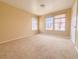 Bright bedroom with carpet, neutral paint, and windows providing natural light at 7840 Millhopper Ave, Las Vegas, NV 89128