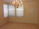Dining area featuring a contemporary chandelier and large windows with natural light at 7840 Millhopper Ave, Las Vegas, NV 89128