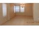 Open-concept dining area with large windows and contemporary lighting at 7840 Millhopper Ave, Las Vegas, NV 89128
