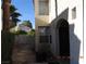 Side entrance featuring a stone walkway and mature landscaping at 7840 Millhopper Ave, Las Vegas, NV 89128