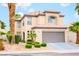 Charming two-story home featuring desert landscaping and a two-car garage at 7840 Millhopper Ave, Las Vegas, NV 89128