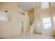 Bright, open foyer with tile flooring, a staircase, and ample natural light at 7840 Millhopper Ave, Las Vegas, NV 89128