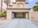 Exterior view showing a two-car garage with an open door at 7840 Millhopper Ave, Las Vegas, NV 89128
