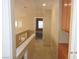 Bright hallway featuring tile flooring and neutral walls, leading to other rooms at 7840 Millhopper Ave, Las Vegas, NV 89128