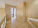 Upstairs hallway features neutral paint, tile flooring, and a view into the spacious living area at 7840 Millhopper Ave, Las Vegas, NV 89128