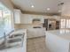 Spacious kitchen features white cabinets, stainless appliances, granite countertops and a center island at 7840 Millhopper Ave, Las Vegas, NV 89128