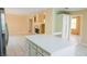 Open kitchen features a center island, stainless appliances and a clear view to the living area with fireplace at 7840 Millhopper Ave, Las Vegas, NV 89128