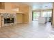 Open living area features a fireplace, easy access to the kitchen and backyard views at 7840 Millhopper Ave, Las Vegas, NV 89128