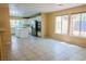 Spacious living area with tile floors and large windows provide ample natural light into the area at 7840 Millhopper Ave, Las Vegas, NV 89128
