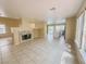 Open-concept living room featuring a fireplace and easy access to the backyard pool at 7840 Millhopper Ave, Las Vegas, NV 89128