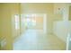 Bright living room with tile flooring, large windows, and an elegant chandelier at 7840 Millhopper Ave, Las Vegas, NV 89128