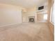 Large living room features a fireplace and an entertainment nook with neutral carpeting at 7840 Millhopper Ave, Las Vegas, NV 89128