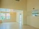 Spacious living room featuring neutral walls, tile floors, chandelier, and great natural light at 7840 Millhopper Ave, Las Vegas, NV 89128