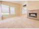 Inviting living area featuring a tiled fireplace, large windows and a view of the outdoors at 7840 Millhopper Ave, Las Vegas, NV 89128