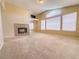 Spacious living area with fireplace, large windows, and vaulted ceilings perfect for gatherings at 7840 Millhopper Ave, Las Vegas, NV 89128