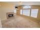 Comfortable living room features a fireplace, arch window, and natural light, creating inviting ambiance at 7840 Millhopper Ave, Las Vegas, NV 89128