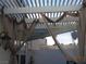 Shaded patio area with decorative curtains, offering a private outdoor space at 7840 Millhopper Ave, Las Vegas, NV 89128