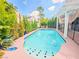 Backyard pool with mature trees and landscaping offering a private retreat at 7840 Millhopper Ave, Las Vegas, NV 89128