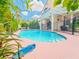 Sparkling pool with patio, pergola, and lush landscaping for outdoor enjoyment at 7840 Millhopper Ave, Las Vegas, NV 89128