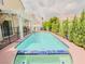 Inviting backyard pool with surrounding greenery and a shaded pergola at 7840 Millhopper Ave, Las Vegas, NV 89128