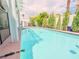 Backyard pool view with privacy landscaping and covered patio area at 7840 Millhopper Ave, Las Vegas, NV 89128