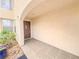 Inviting front porch with tiled flooring and neutral walls at 7840 Millhopper Ave, Las Vegas, NV 89128