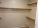 Walk-in closet features wood supports and shelving at 7840 Millhopper Ave, Las Vegas, NV 89128