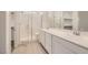 Bright bathroom features tile flooring, double sinks, a glass shower, and walk-in closets at 790 Sunny Sagebrush St, Henderson, NV 89011
