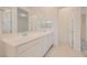 Bright bathroom features tile flooring, double sinks, and a large mirror at 790 Sunny Sagebrush St, Henderson, NV 89011