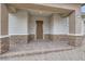 Inviting front porch with brick columns and textured stucco walls providing a warm and welcoming entrance at 790 Sunny Sagebrush St, Henderson, NV 89011