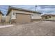 View of the home garage featuring a brick-accented facade and neutral tones in a well-maintained neighborhood at 790 Sunny Sagebrush St, Henderson, NV 89011