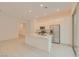 Bright kitchen features white cabinetry, stainless appliances, granite counters, and tile flooring at 790 Sunny Sagebrush St, Henderson, NV 89011