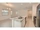 Bright kitchen offers granite counters, stainless appliances, a kitchen island, and tile flooring at 790 Sunny Sagebrush St, Henderson, NV 89011