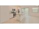Bright kitchen includes granite countertops, stainless appliances, tile flooring, and sliding glass doors at 790 Sunny Sagebrush St, Henderson, NV 89011