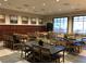Well-lit meeting room with several tables and chairs, brown storage lockers, and views from multiple windows at 790 Sunny Sagebrush St, Henderson, NV 89011
