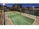 Aerial view of a fully fenced and well-lit pickleball court ready for evening games at 790 Sunny Sagebrush St, Henderson, NV 89011