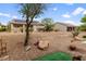 Large, low maintenance desert landscaped backyard with mature trees and gravel at 7934 Kiskadee St, North Las Vegas, NV 89084