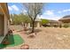 Spacious backyard with desert landscaping and seating area, ready for your personal touch at 7934 Kiskadee St, North Las Vegas, NV 89084