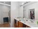 Bathroom with dual sinks and updated walk-in shower at 7934 Kiskadee St, North Las Vegas, NV 89084