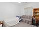 Bedroom featuring neutral colors, ceiling fan, and bookshelf at 7934 Kiskadee St, North Las Vegas, NV 89084