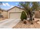 Inviting home showcasing a two-car garage, desert landscaping, and a well-kept front yard at 7934 Kiskadee St, North Las Vegas, NV 89084