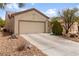 Charming single-story home with a two-car garage, desert landscaping, and a welcoming entrance at 7934 Kiskadee St, North Las Vegas, NV 89084