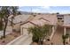 Charming single-story home featuring an inviting front porch, desert landscaping and attached two car garage at 7934 Kiskadee St, North Las Vegas, NV 89084