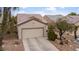 Charming single-story home featuring an inviting front porch, desert landscaping and attached two car garage at 7934 Kiskadee St, North Las Vegas, NV 89084