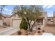 Charming home featuring a quaint front porch, desert landscaping and attached two car garage at 7934 Kiskadee St, North Las Vegas, NV 89084