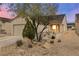 Inviting home exterior featuring desert landscaping and a cozy front porch seating area at 7934 Kiskadee St, North Las Vegas, NV 89084