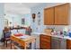 Open kitchen with view to living room, wooden cabinets, and tiled floor at 7934 Kiskadee St, North Las Vegas, NV 89084