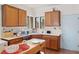 Efficient kitchen layout featuring wooden cabinets, stainless steel appliances, and a window at 7934 Kiskadee St, North Las Vegas, NV 89084