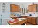 Charming kitchen featuring wooden cabinets, white countertops, and natural light at 7934 Kiskadee St, North Las Vegas, NV 89084