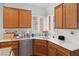 Bright kitchen with wooden cabinets, stainless steel appliances, and ample countertop space at 7934 Kiskadee St, North Las Vegas, NV 89084